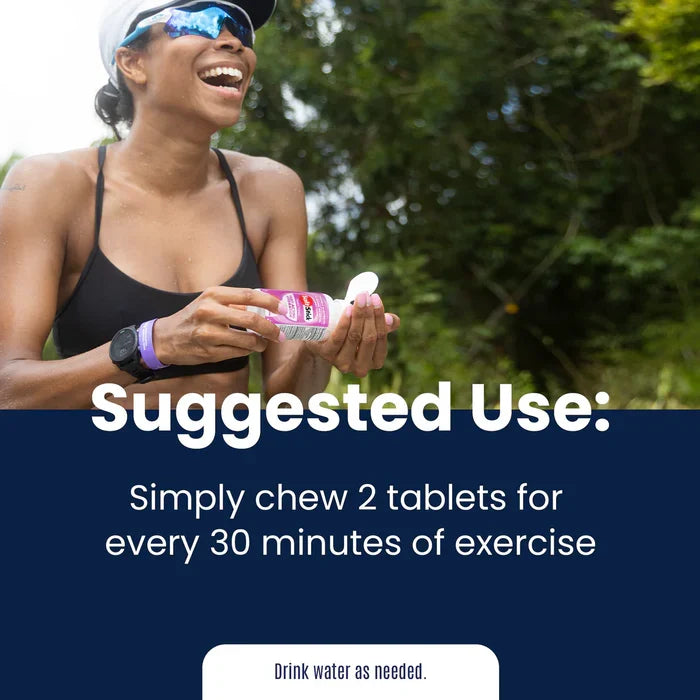 Active woman outdoors holding SaltStick FastChews - Chewable Electrolytes - Lemon Lime - 25 Serves packaging, smiling.