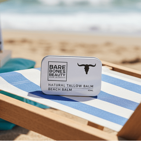 Beach Tallow Balm - 40ml by Bare Bones Beauty in a metal tin on a blue-striped chair at the beach.