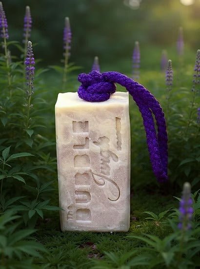 Bloomin' Lavender Tallow Soap - 175g by The Bubble Jungle, in a garden setting with purple flowers nearby.