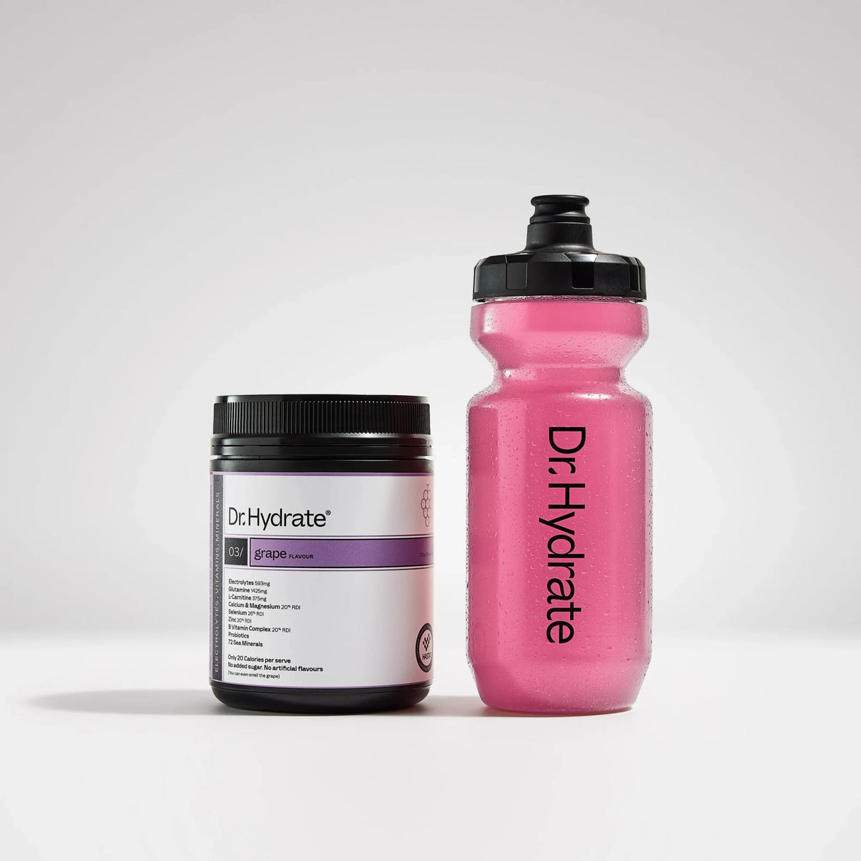 Dr. Hydrate Grape Jar - 30 Serves container with purple label next to filled pink Dr. Hydrate bottle on white background