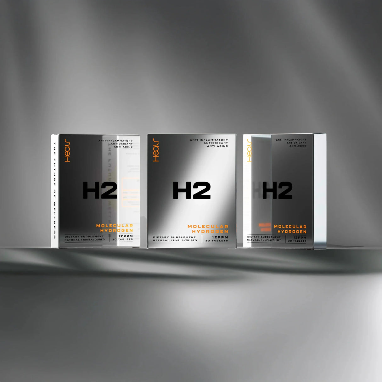 Three reflective silver boxes of H2 Hydrogen Water - Unflavoured - 30 Tablets by Healr displayed on a grey surface