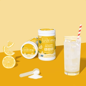 Lemonade Electrolyte Drink Mix - 90 Serves by Ultima Replenisher with lemon slices and mixed drink on yellow background