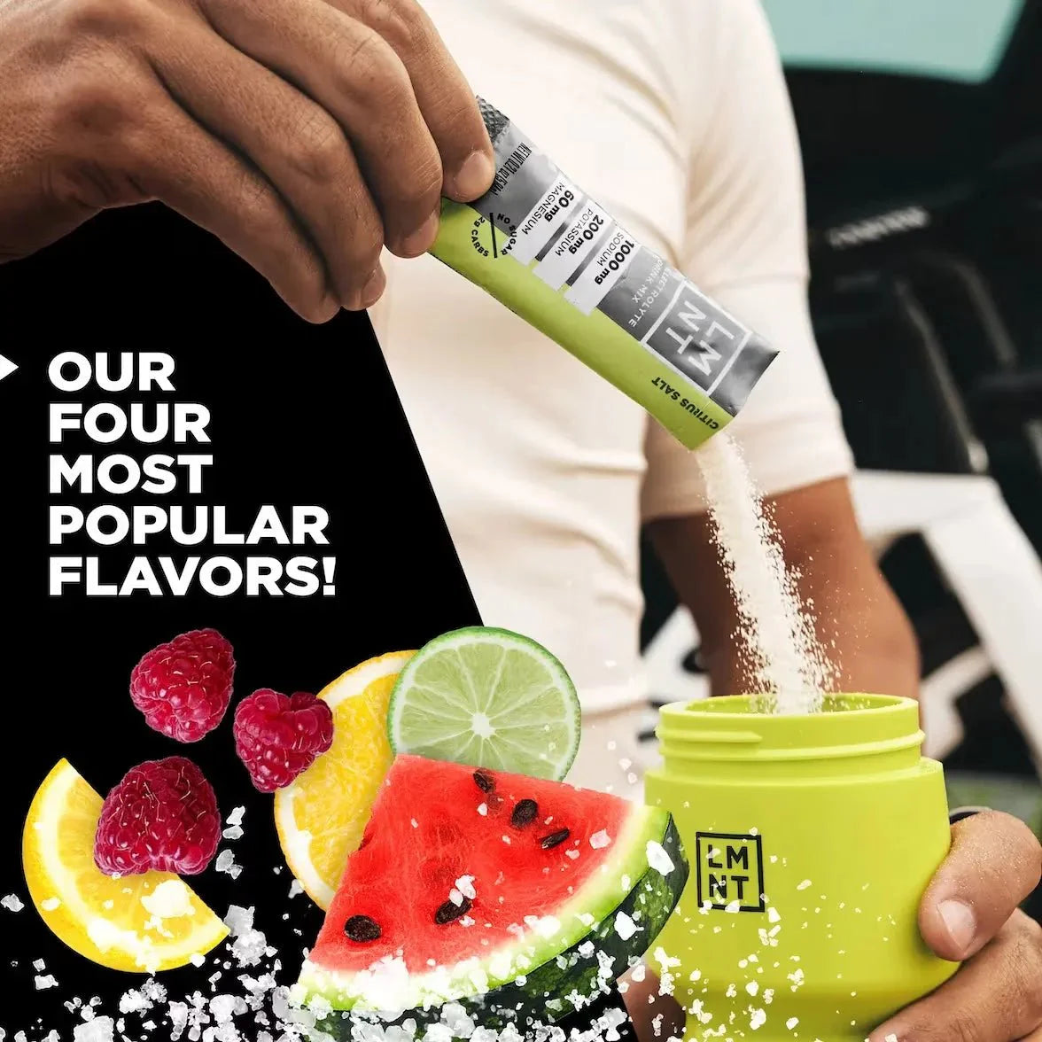 LMNT Variety Pack - 12 Sticks being poured into a green container with fresh raspberry, lemon, lime, and watermelon representing popular electrolyte flavors by LMNT.