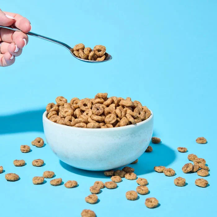 Protein Cereal - Cinnamon Flavour - 250g by Low Carb Emporium in a white bowl with a spoonful against blue background