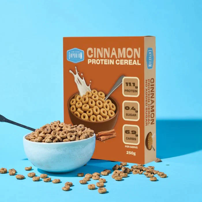 Protein Cereal - Cinnamon Flavour - 250g by Low Carb Emporium with a bowl of cereal and cinnamon sticks on blue background