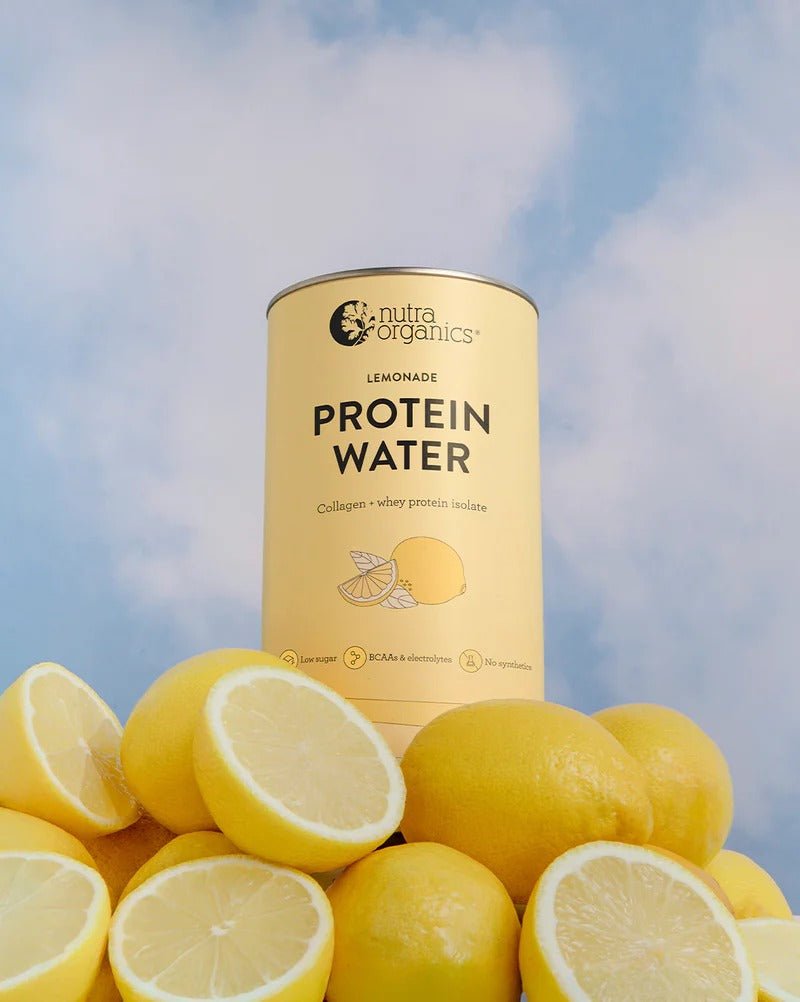 Nutra Organics Protein Water - Lemonade - 450g can on fresh lemons with blue sky backdrop in New Arrivals collection