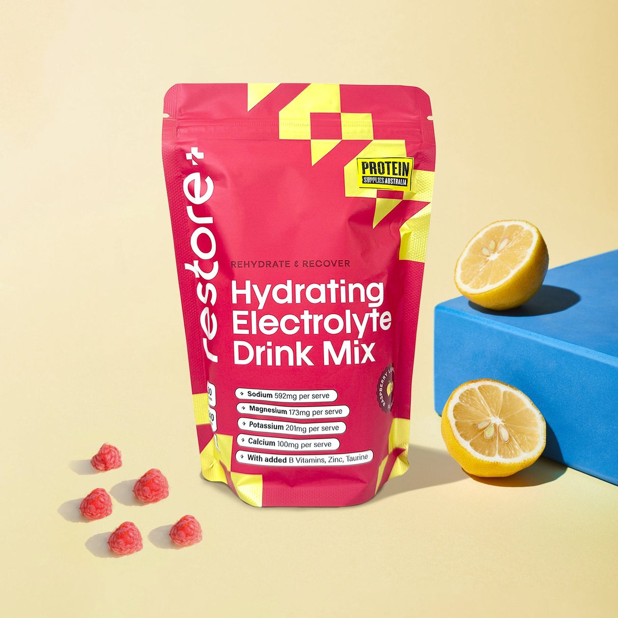 Restore Electrolyte Drink Mix Raspberry Lemonade 240g pouch with raspberries and lemon halves displayed on light background