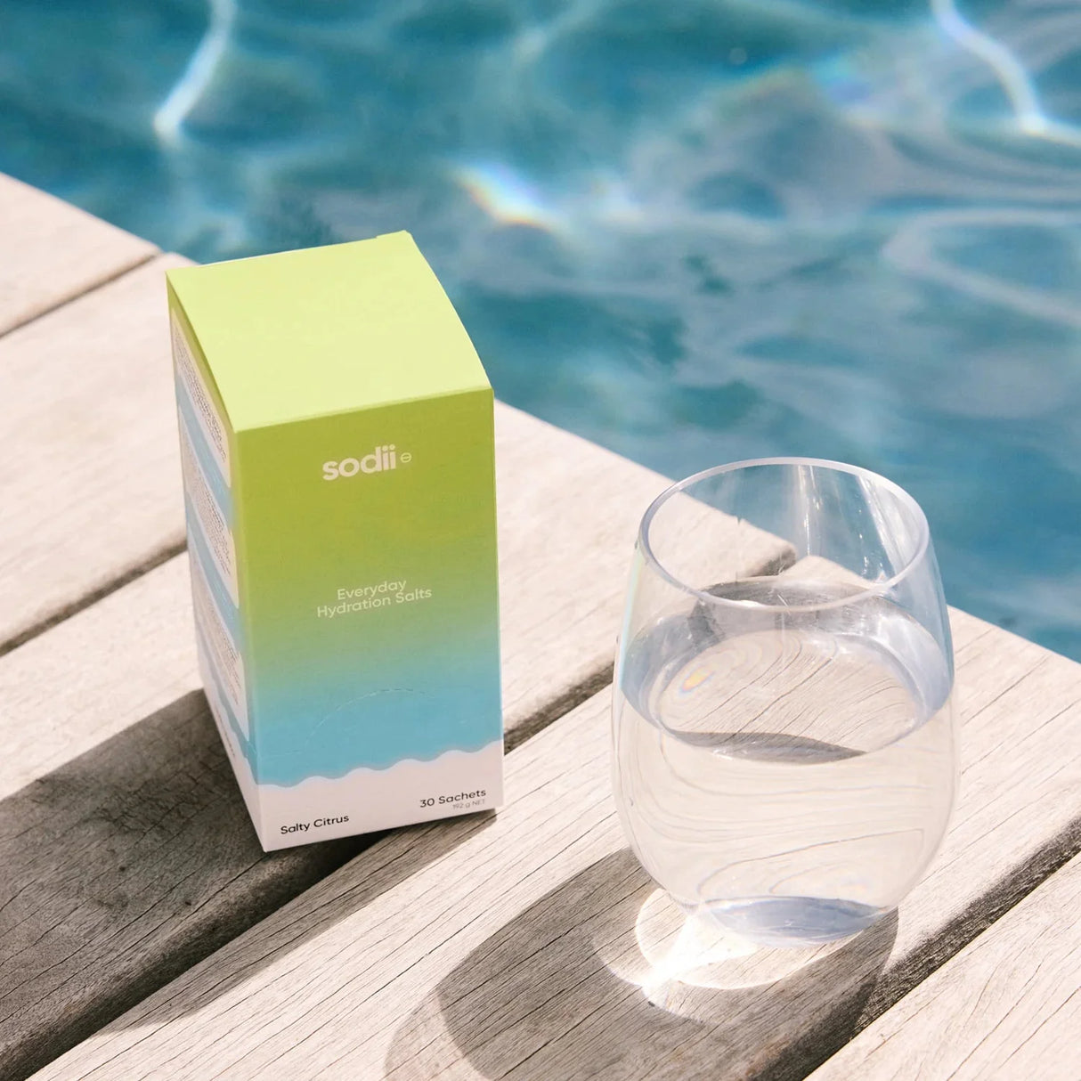 Salty Citrus - 30 Sachets by Sodii beside a glass of water poolside, from Drinks, Electrolytes, New Arrivals collections
