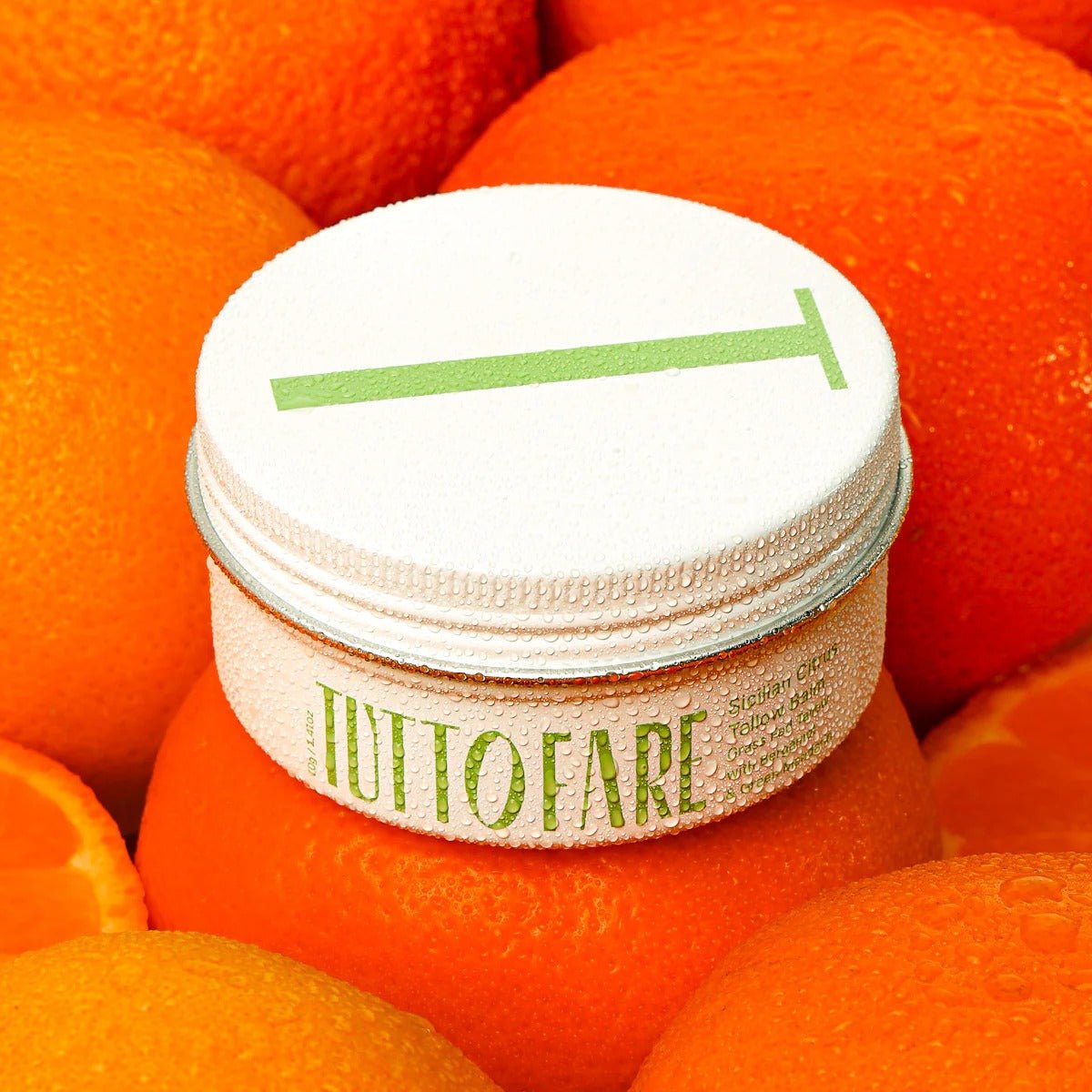 Sicillian Citrus Tallow Balm - 70g by Tuttofare, skincare balm jar surrounded by fresh bright oranges for natural body care.
