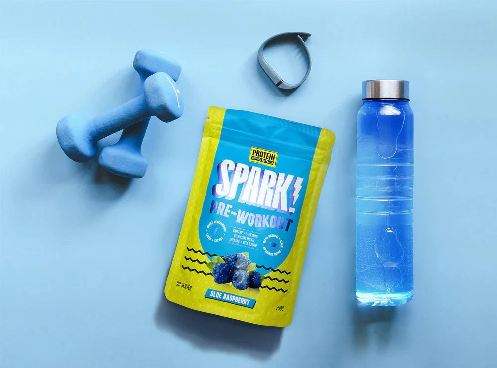 Spark Pre-workout - Blue Raspberry - 250g by Protein Supplies Australia with dumbbells and water bottle on blue background