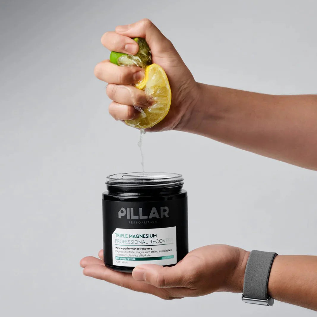 Triple Magnesium Powder - Lemon Lime - 200g by PILLAR PERFORMANCE shown with fresh lemon and lime juice squeeze