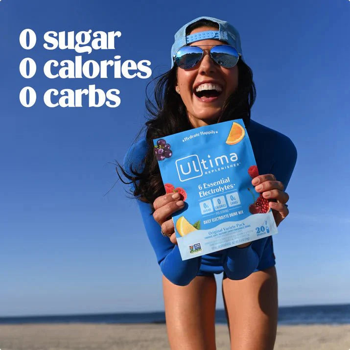 Woman holding Variety Pack - Electrolyte Drink Mix - 20 ct by Ultima Replenisher with text zero sugar calories carbs