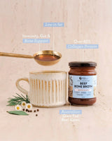 Beef Bone Broth Concentrate - Natural - 250g jar with ceramic cup and gold spoon highlighting collagen and bone support benefits