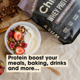 Grass-fed Whey Protein Powder - Smooth Chocolate - 900g by Chief next to yogurt bowl with berries and nuts for Keto and Low Carb diets