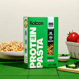 Kaizen Protein Pasta Fusilli box beside a bowl of cooked fusilli and fresh tomatoes