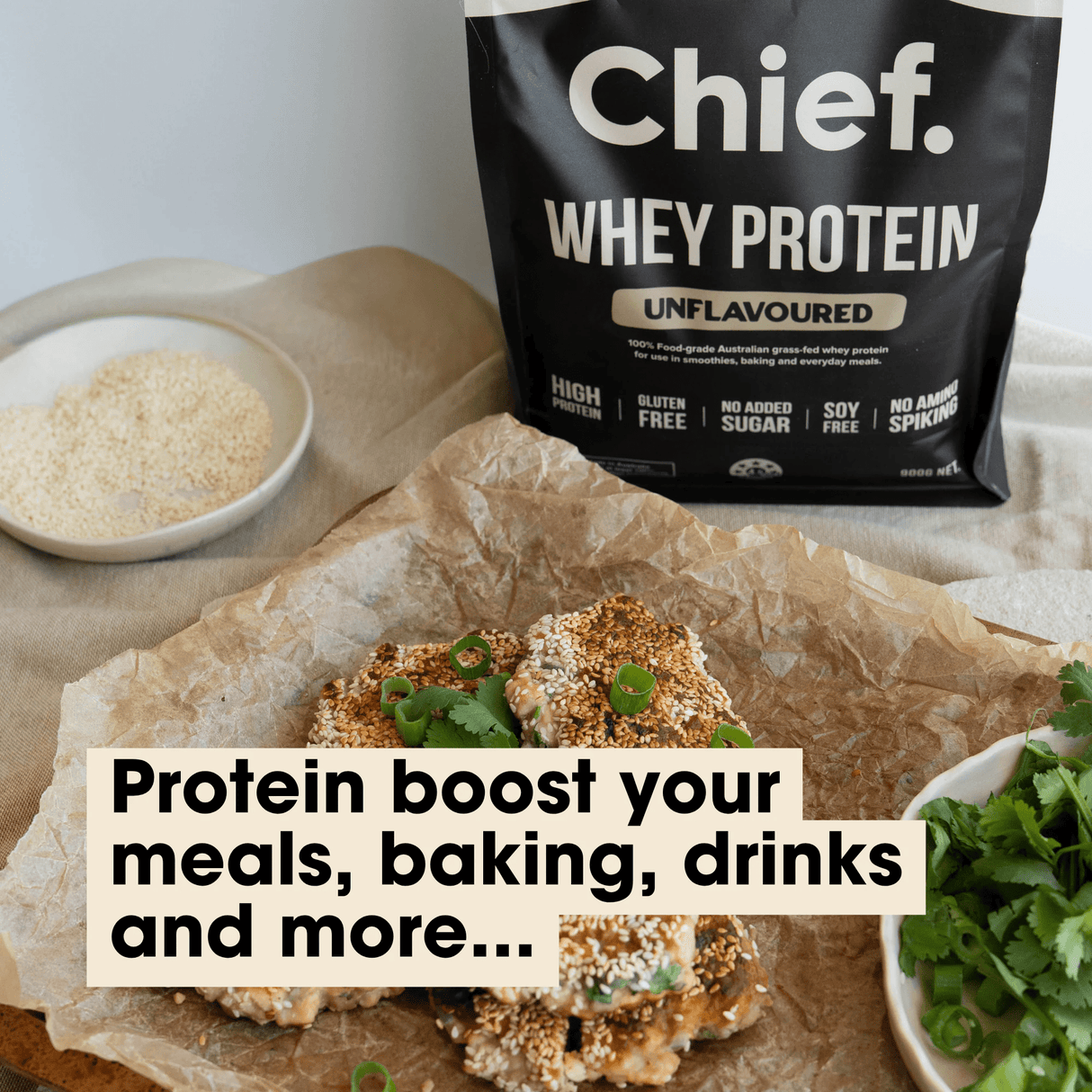 Chief Grass-fed Whey Protein Powder - Unflavoured - 900g pouch with baked snacks and fresh herbs on parchment paper