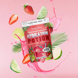 Hydration Potion Strawberry Lime - 165g by Botanika Blends surrounded by strawberries, limes, and splash on pink background