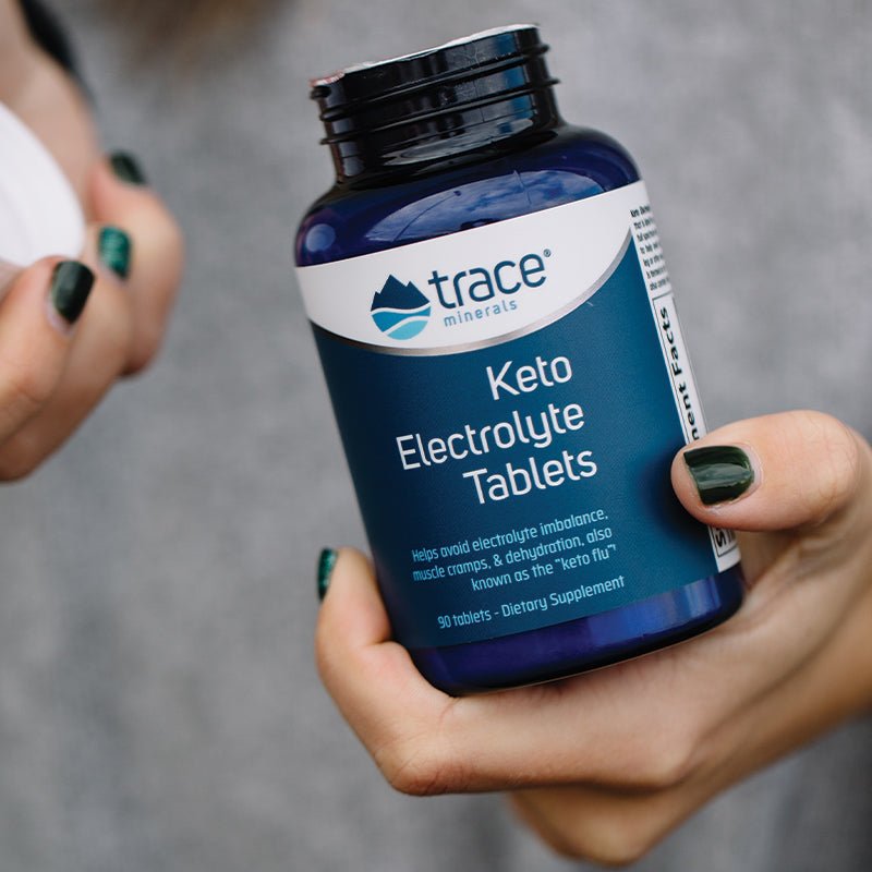 Bottle of Trace Minerals Keto Electrolyte Tablets - 90 Tablets held in hand, promoting hydration and muscle support.