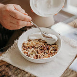 Keto Premium Paleo Granola - Macadamia & Coconut - 300g by Brookfarm served with creamy yogurt in a white bowl.