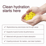 Hands holding yellow gummies with benefits of Swoleys LyteBites - Electrolyte Gummies - Lemon Surge for clean hydration and muscle support