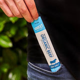 Hand holding a KOOEE! Organic Beef Stick Sea Salt snack from the Organic Beef Stick - Sea Salt - Box of 20 pack.