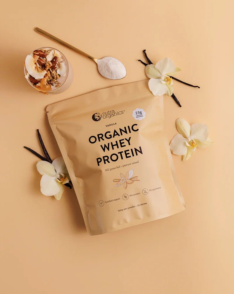 Organic Whey Protein - Vanilla - 750g pack by Nutra Organics with vanilla pods, flowers, and powder spoon on beige background