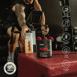 Power Perform Pre-Workout Blend - Strawberry Kiwi - 30 Serves container and Switch Nutrition bottle near person cycling indoors