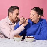 Couple enjoying Protein Cereal - Chocolate Flavour - 250g by Low Carb Emporium with Keto-friendly Yo Keto branding