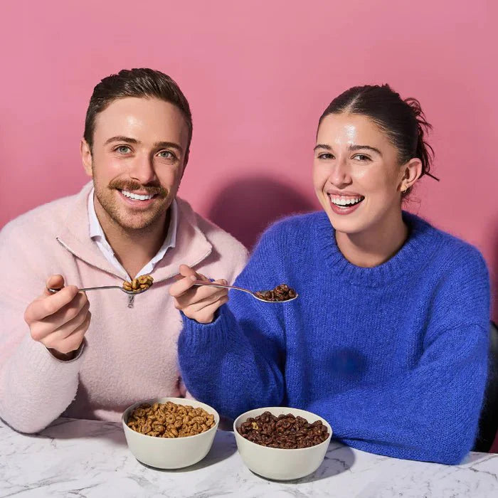 Two people enjoying Protein Cereal - Chocolate Flavour - 250g by Low Carb Emporium, a keto low carb snack option